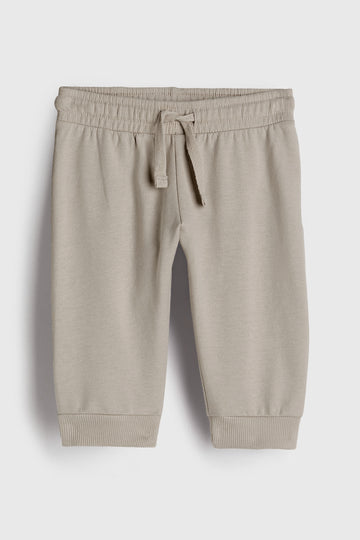 Beige jogger pants on a white background