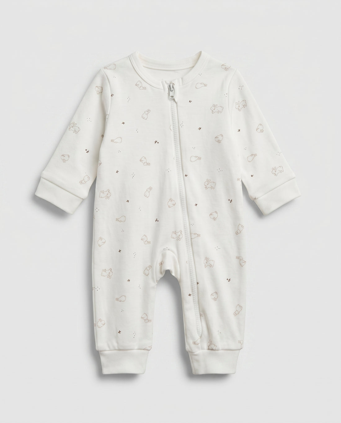 Ivory baby long-sleeve zip-up romper with all-over scattered bunny and bird print in taupe, featuring front zip closure with inner guard flap and ribbed cuffs at wrists and ankles