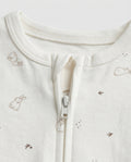 Ivory baby long-sleeve zip-up romper with all-over scattered bunny and bird print in taupe, featuring front zip closure with inner guard flap and ribbed cuffs at wrists and ankles