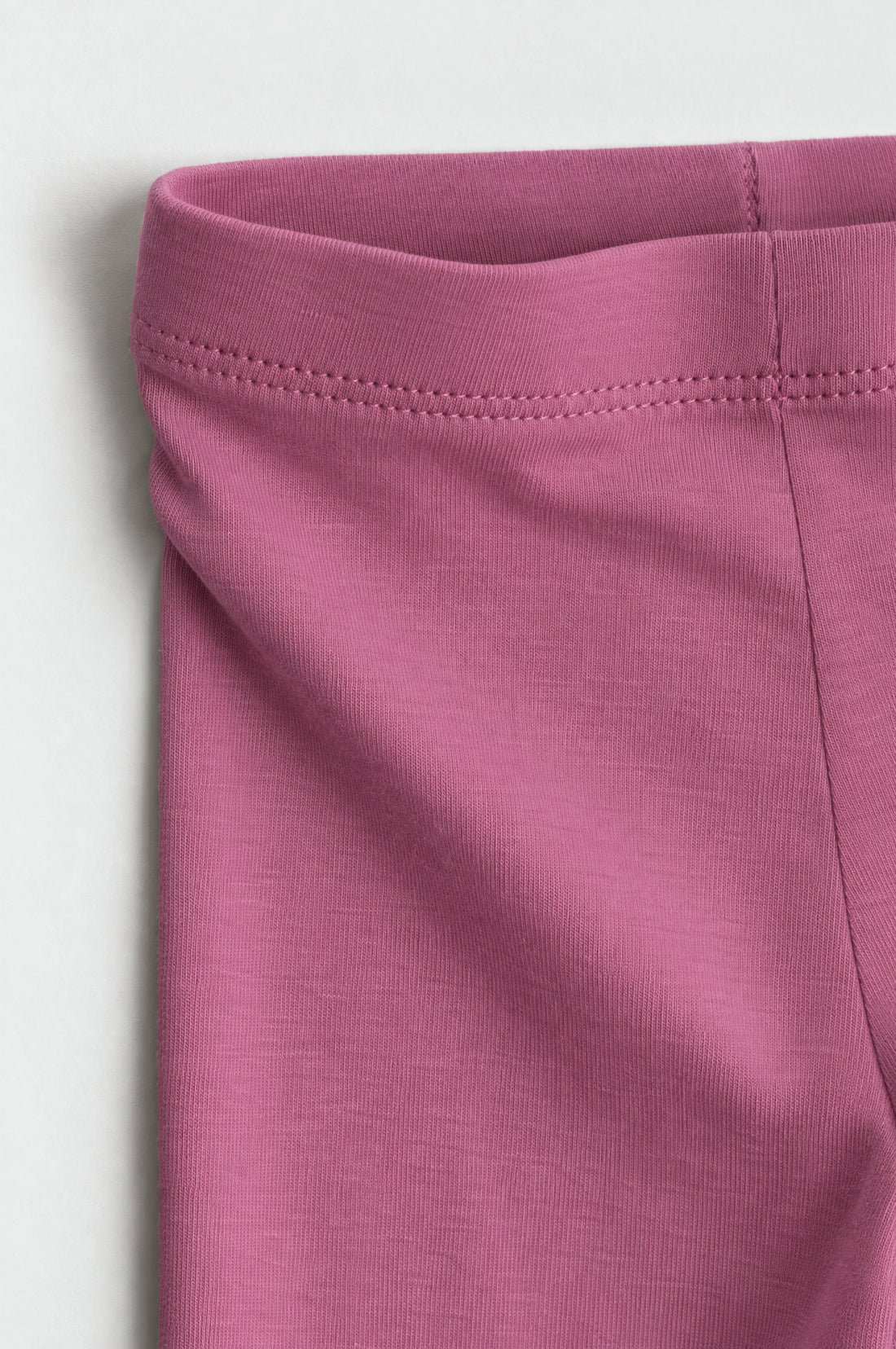 Rose pink toddler girls leggings with elasticated waistband, slim fitted legs and neatly finished ankle hems on a clean white background.