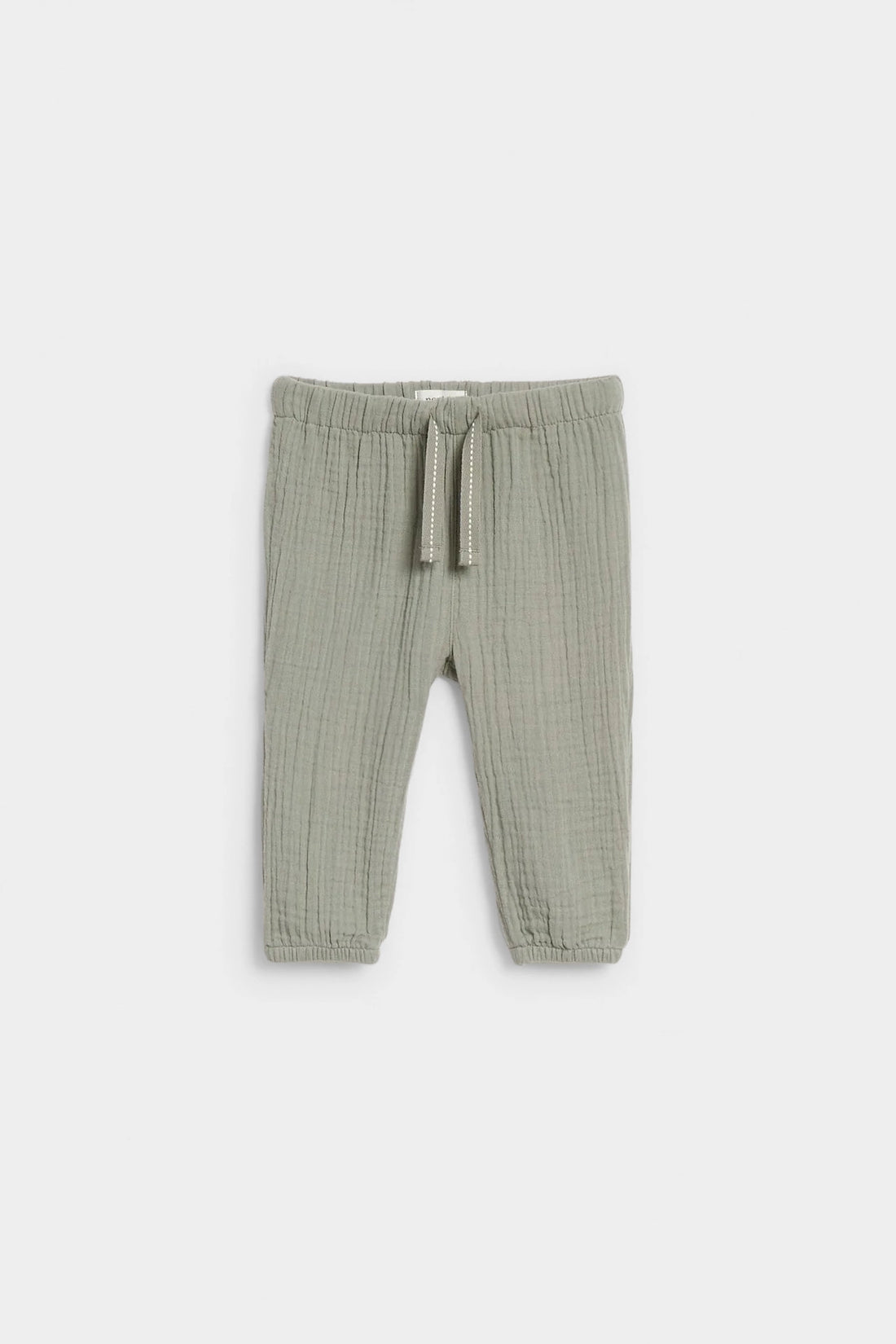 Sage green baby muslin drawstring trousers with elasticated waist and ankle cuffs, flat lay — PTex Fashion