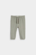 Sage green baby muslin drawstring trousers with elasticated waist and ankle cuffs, flat lay — PTex Fashion