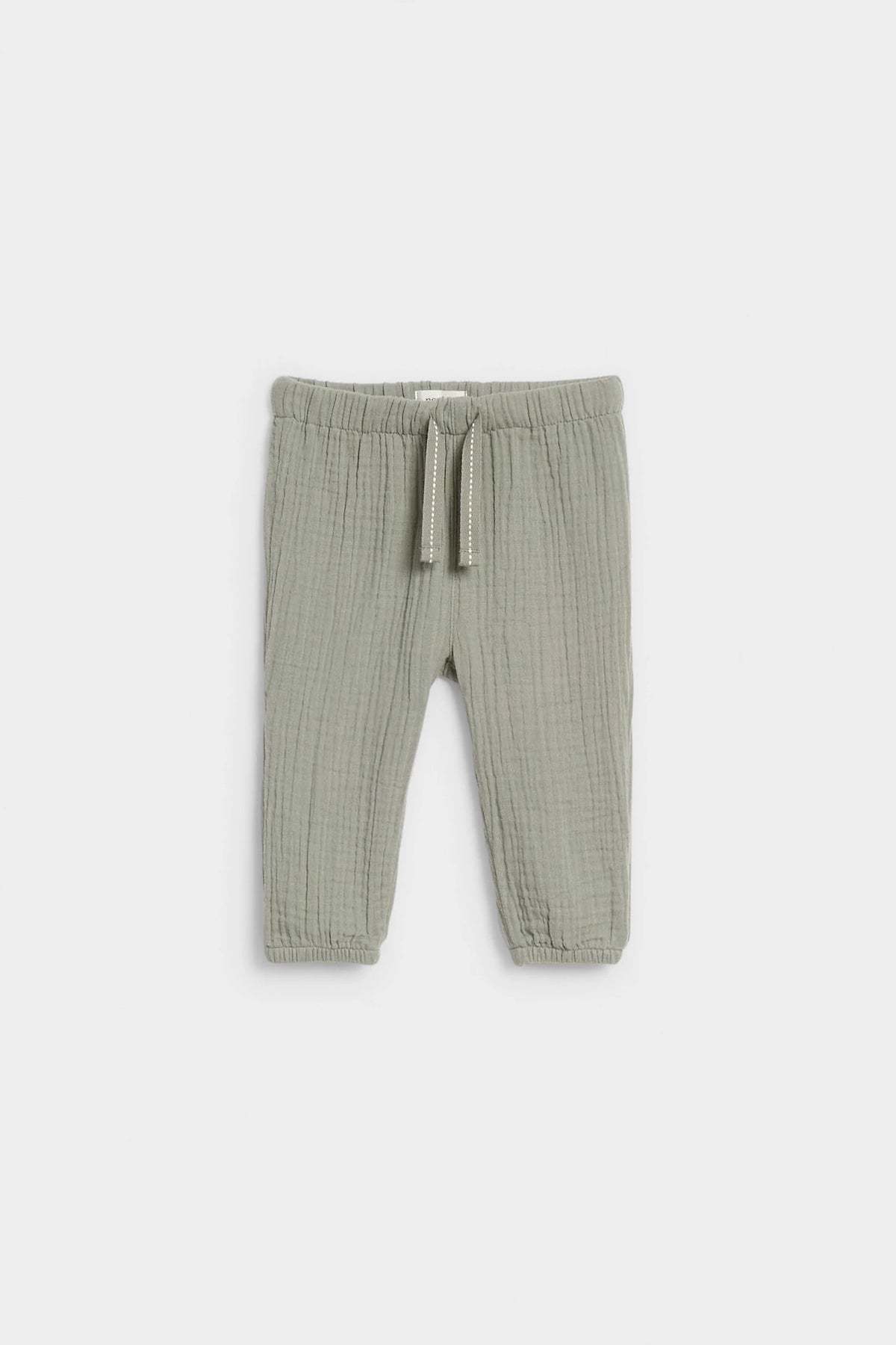 Sage green baby muslin drawstring trousers with elasticated waist and ankle cuffs, flat lay — PTex Fashion