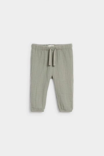 Sage green baby muslin drawstring trousers with elasticated waist and ankle cuffs, flat lay — PTex Fashion