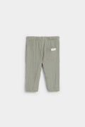 Back view of sage green baby muslin trousers showing patch pocket and elasticated waist — PTex Fashion