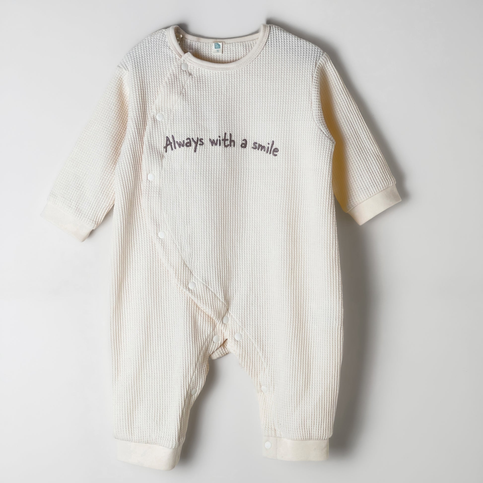 Baby Romper in beige color with a waffle fabric pattern