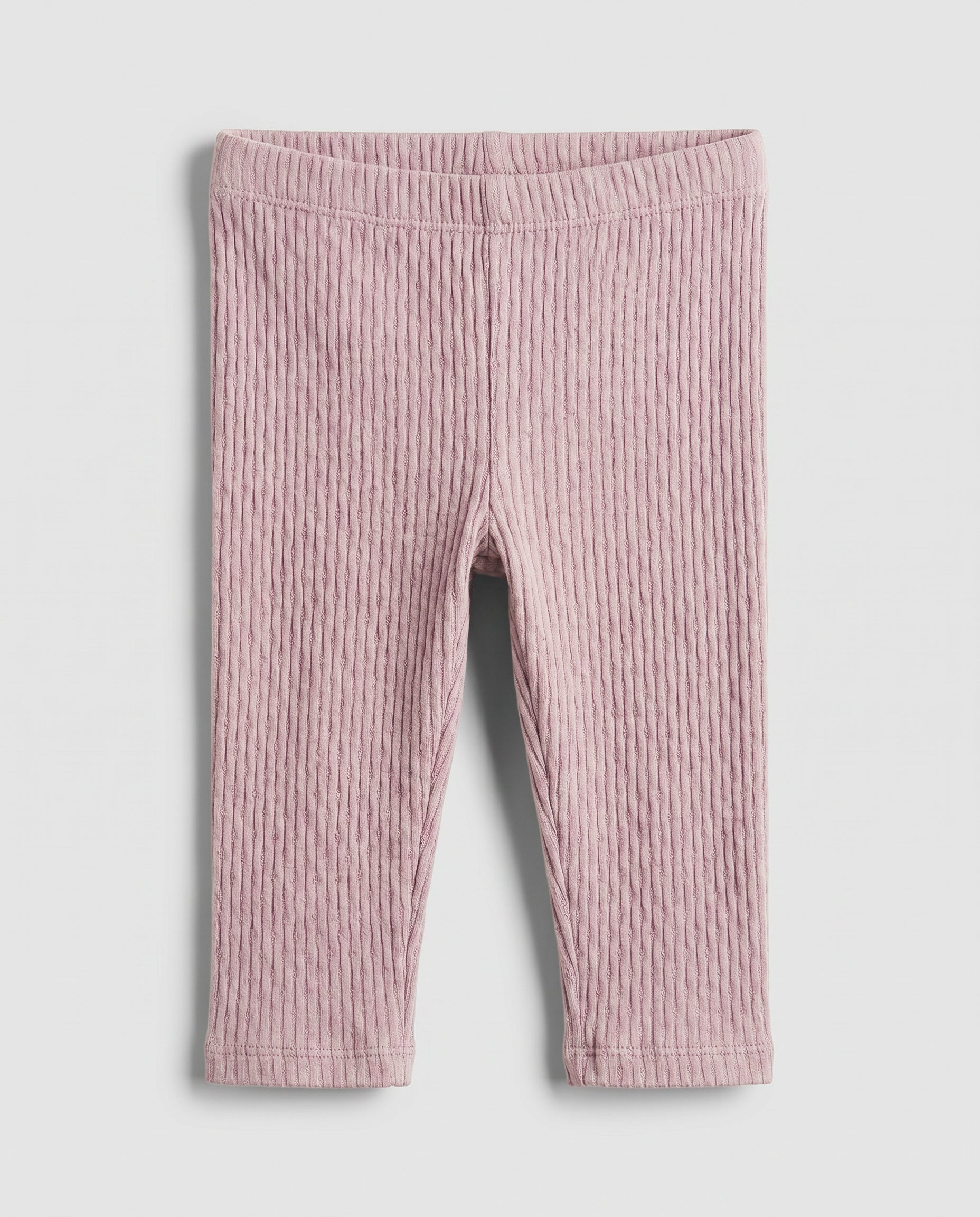 Baby girls' blush pink cable-knit leggings with textured ribbed pattern, flat lay