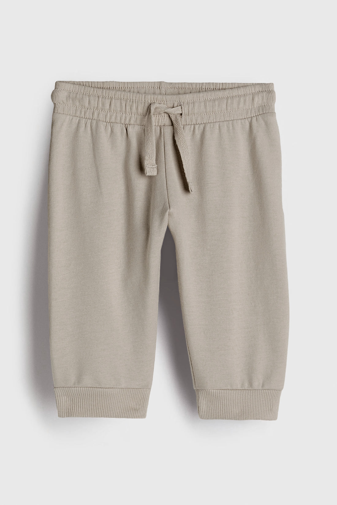 Beige jogger pants on a white background