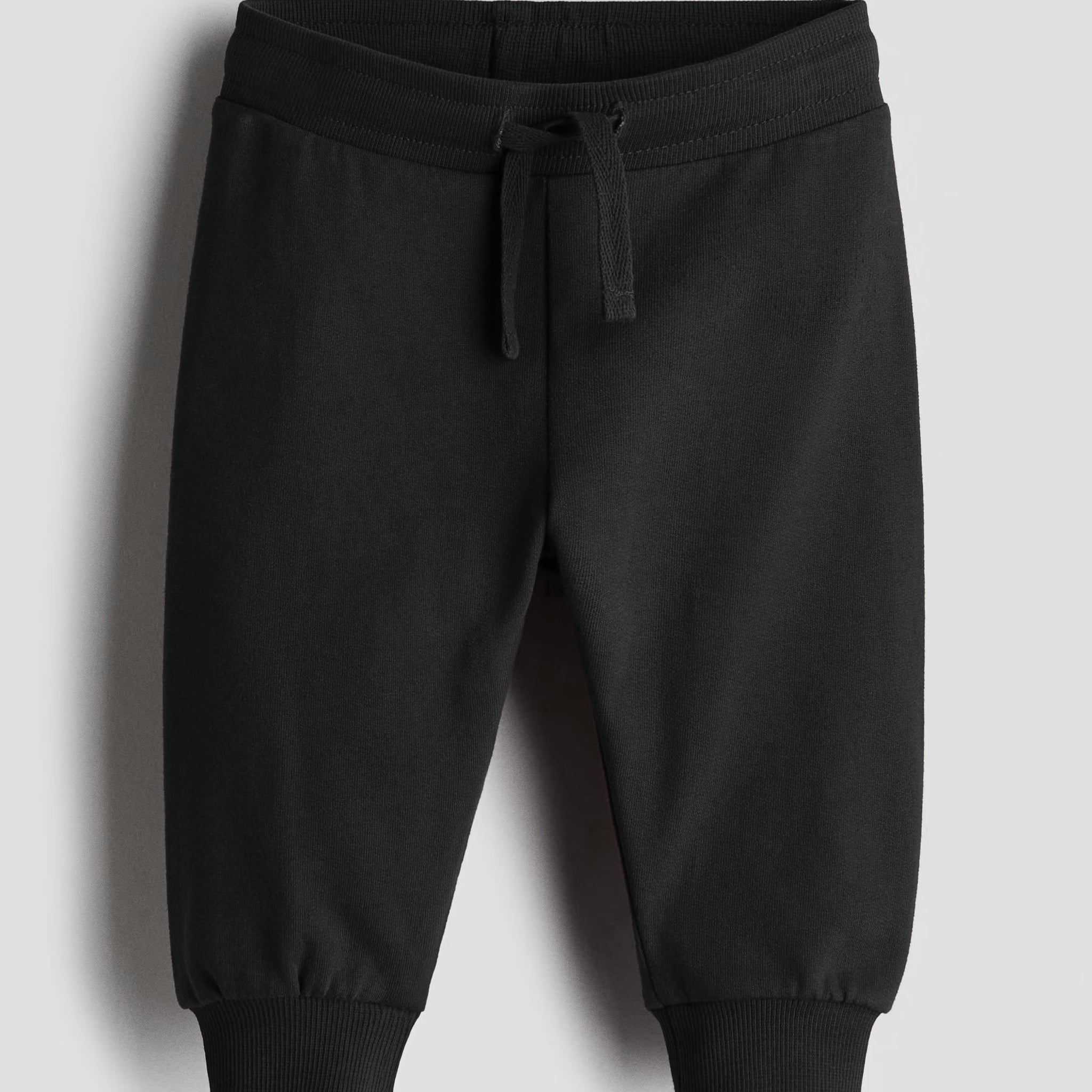 Black sweatpants on a light gray background