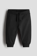 Black sweatpants on a light gray background