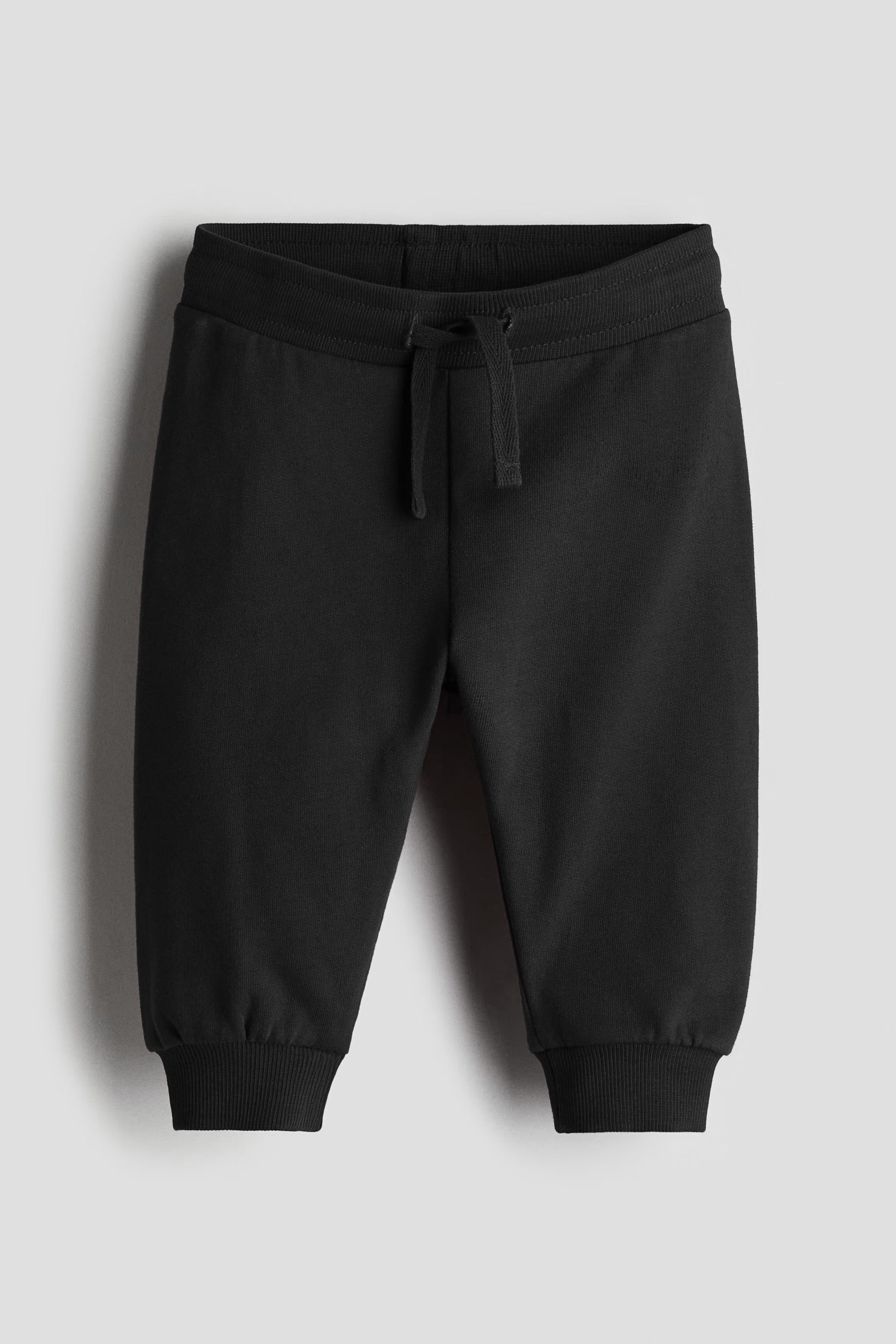 Black sweatpants on a light gray background