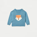 Blue sweater with fox face design on a light gray background