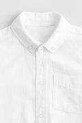 Close-up of a white shirt with a collar on a light gray background