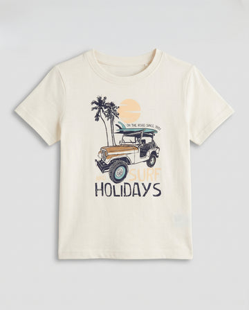 Boys' off white half sleeve cotton t-shirt with surf and holidays adventure graphic, flat lay product photo on light grey background.