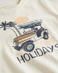Close-up of boys' off white cotton t-shirt with vintage beach graphic featuring a 4×4 jeep, surfboards, palm trees, and 