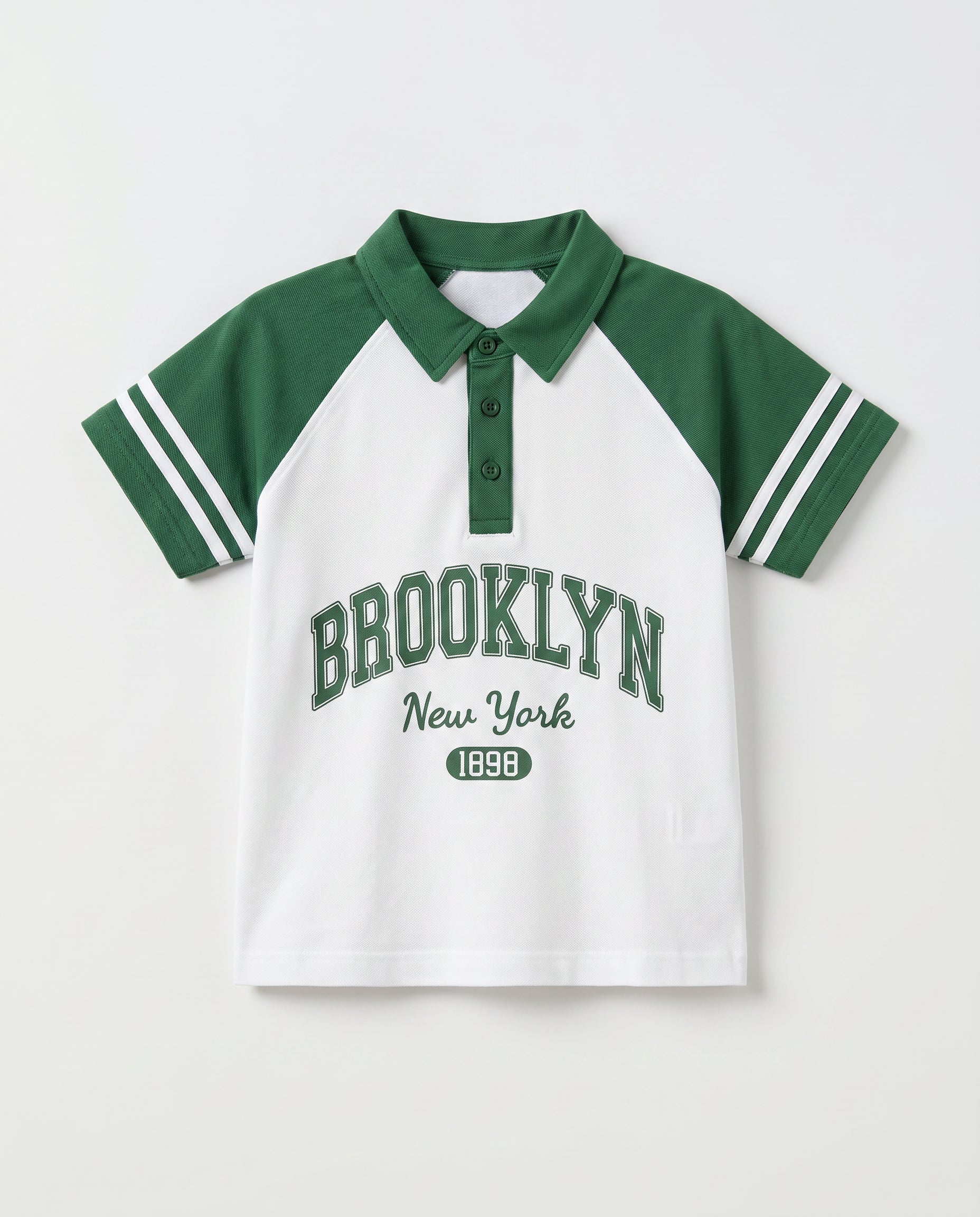 Boys' green and white raglan polo shirt with Brooklyn varsity print and striped sleeve detail, front view