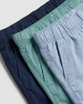 Three-pack of boys' pull-on chino shorts in navy, sage green, and dusty blue, close-up detail of elastic waistbands and side pocket construction