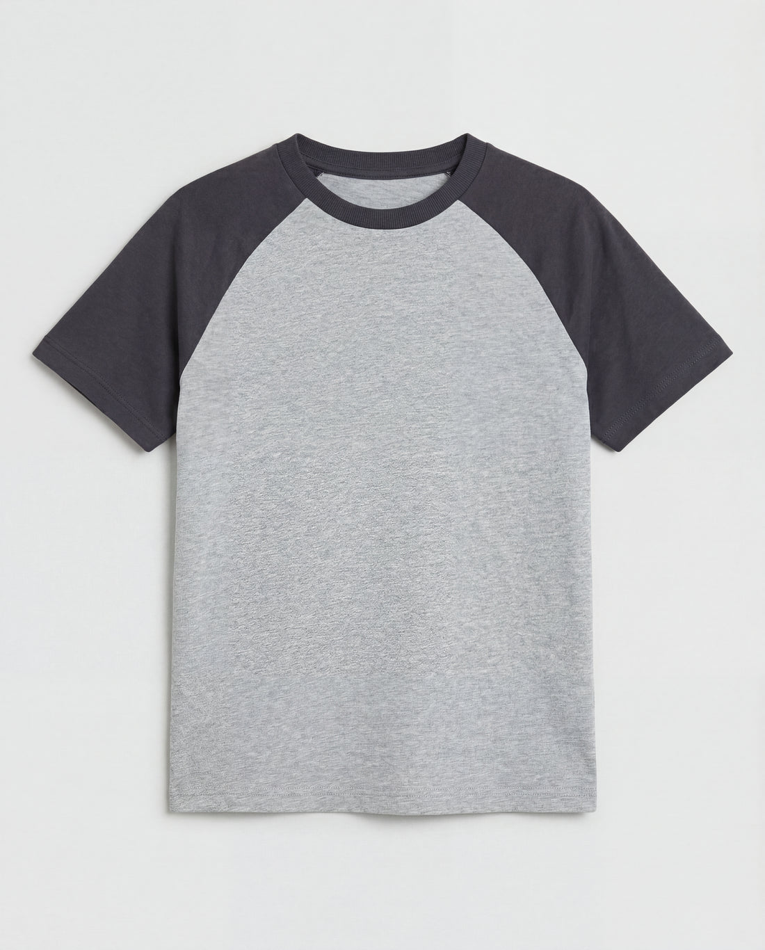 Boys' short-sleeve raglan cotton t-shirt laid flat, featuring a heather grey body with contrast charcoal raglan sleeves and a ribbed crew neckline.