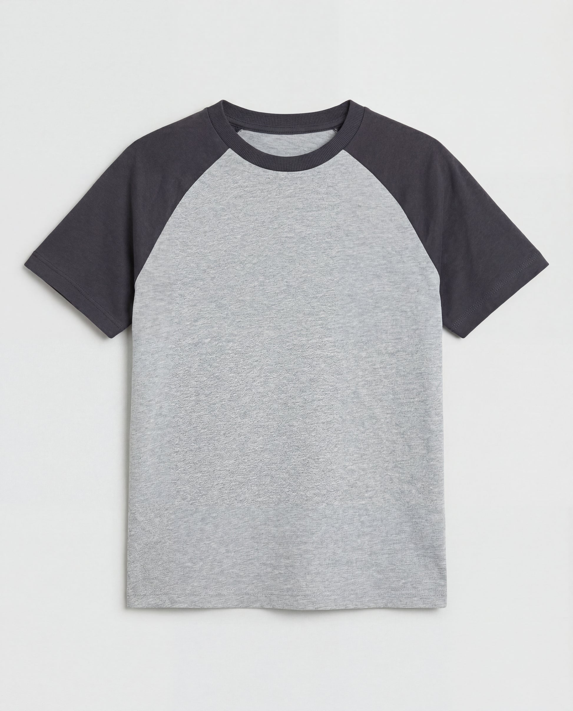 Boys' short-sleeve raglan cotton t-shirt laid flat, featuring a heather grey body with contrast charcoal raglan sleeves and a ribbed crew neckline.