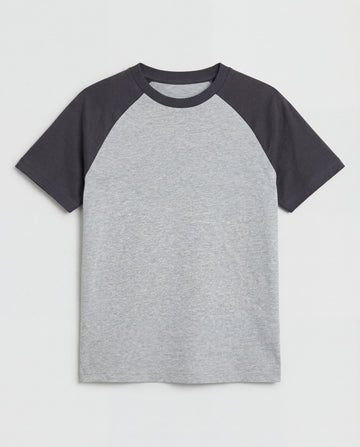 Boys' short-sleeve raglan cotton t-shirt laid flat, featuring a heather grey body with contrast charcoal raglan sleeves and a ribbed crew neckline.