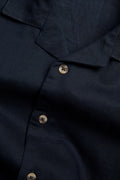 Boys navy linen blend half sleeve shirt with open collar, short sleeves and button-front design in macro image