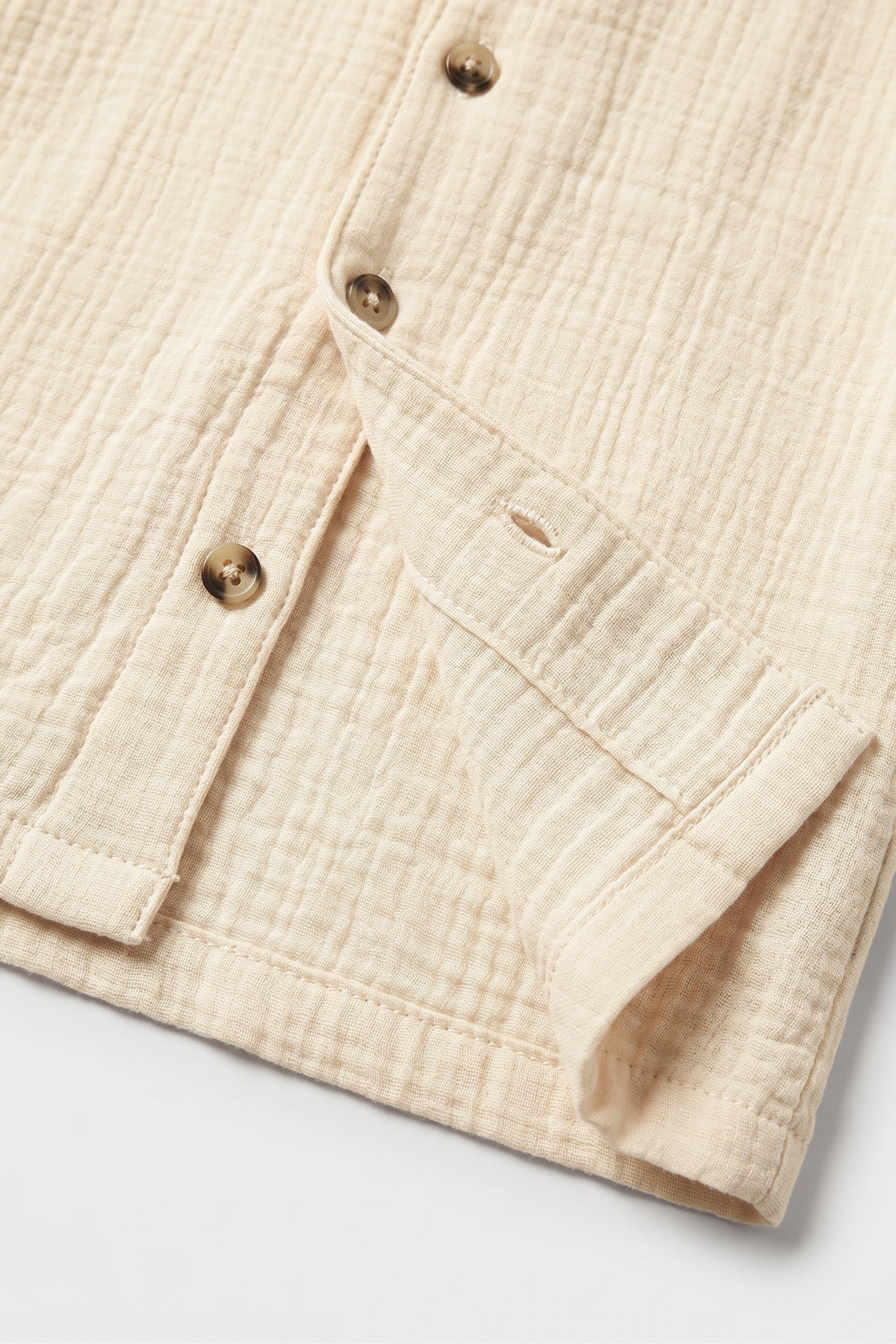 Boys beige muslin cotton short sleeve shirt with camp collar and brown buttons
