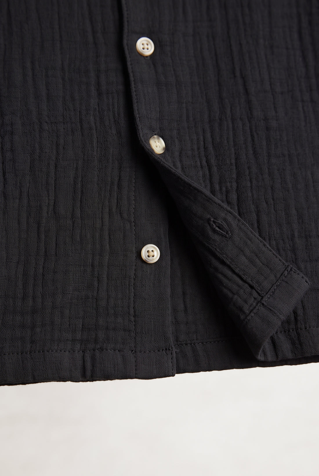 Boys black muslin short sleeve shirt with textured fabric, camp collar and button front