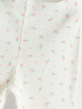 Close-up of a baby outfit with a floral pattern on a white background