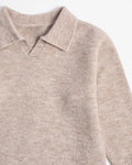 Close-up of a beige kids sweater with a collar on a white background