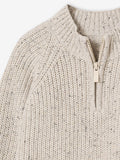 Close-up of a beige knitted sweater with a zipper on a white background