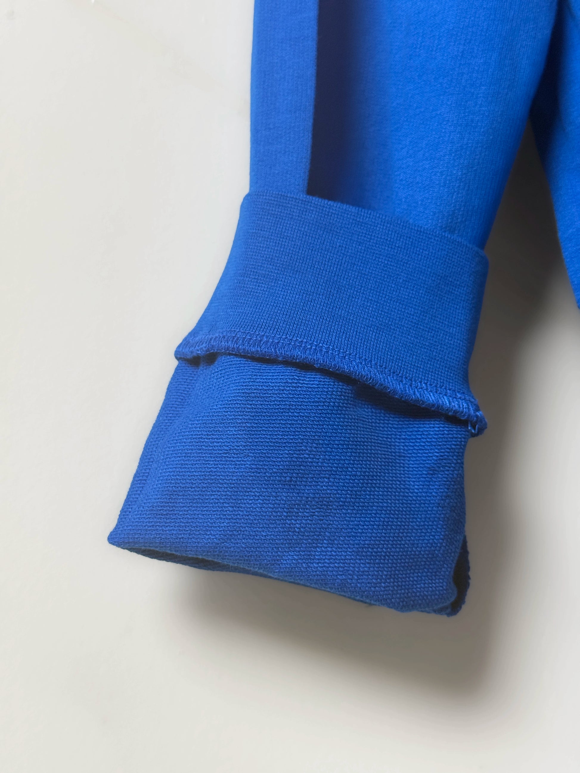 Close-up of a blue fabric roll on a light gray background
