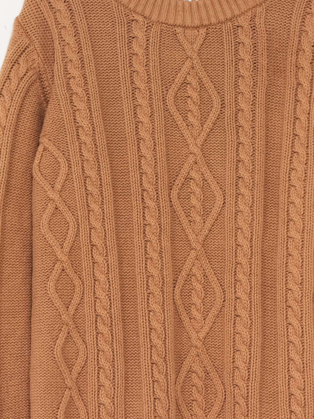 Close-up of a caramel colour cable knit sweater
