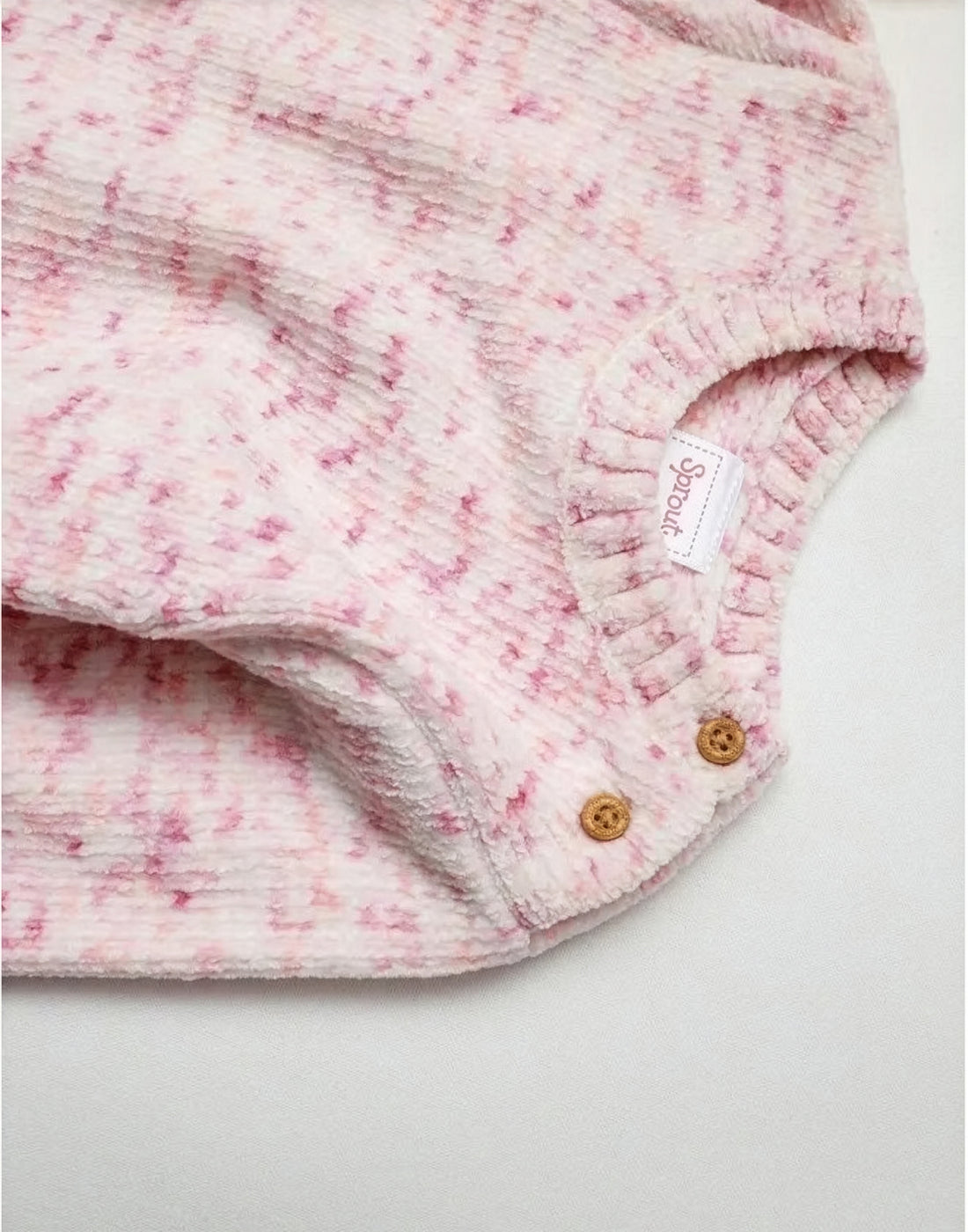 Pink knitted sweater on a white background