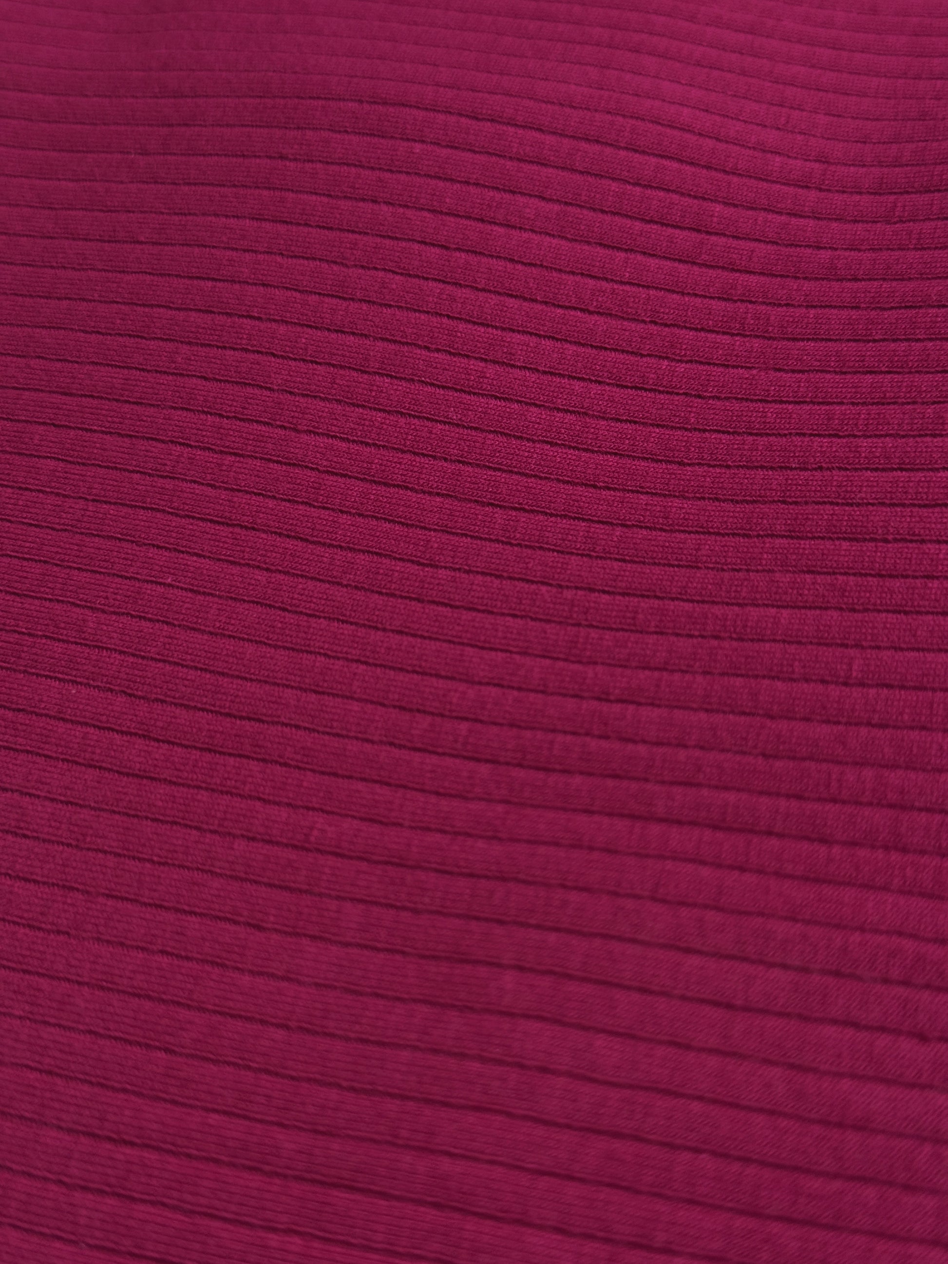 Close-up of a textured light burgundy fabric surface