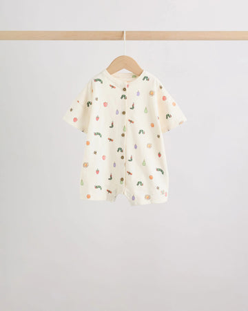 Cream all-over print baby romper with scattered caterpillar and fruit motifs, wooden button front placket, on wooden hanger

