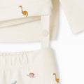 Baby outfit with embroidered animals on a white background