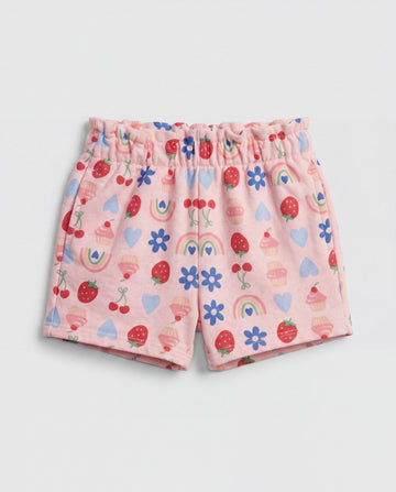 Front flat-lay view of girl's blush pink short pant with all-over multicolour strawberry, cherry, cupcake, rainbow, daisy and heart print and ruched paperbag elasticated waistband