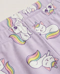 Close-up of lavender kids' leggings with all-over kawaii unicorn cat print featuring white cats with rainbow tails and unicorn horns on a purple background.