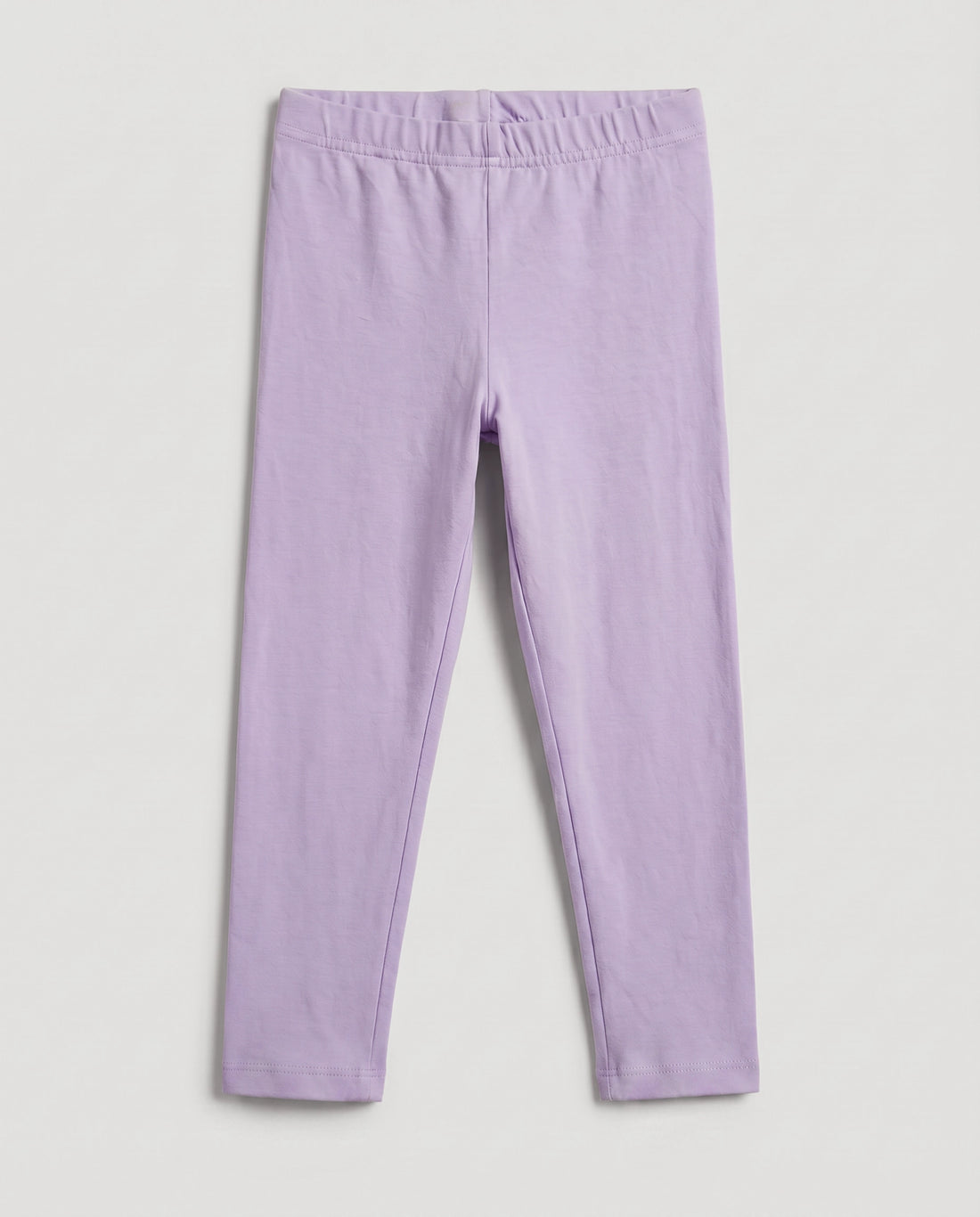 Full-length girls' slim-fit leggings in baby purple, plain design with elasticated waistband, laid flat on a light grey background.