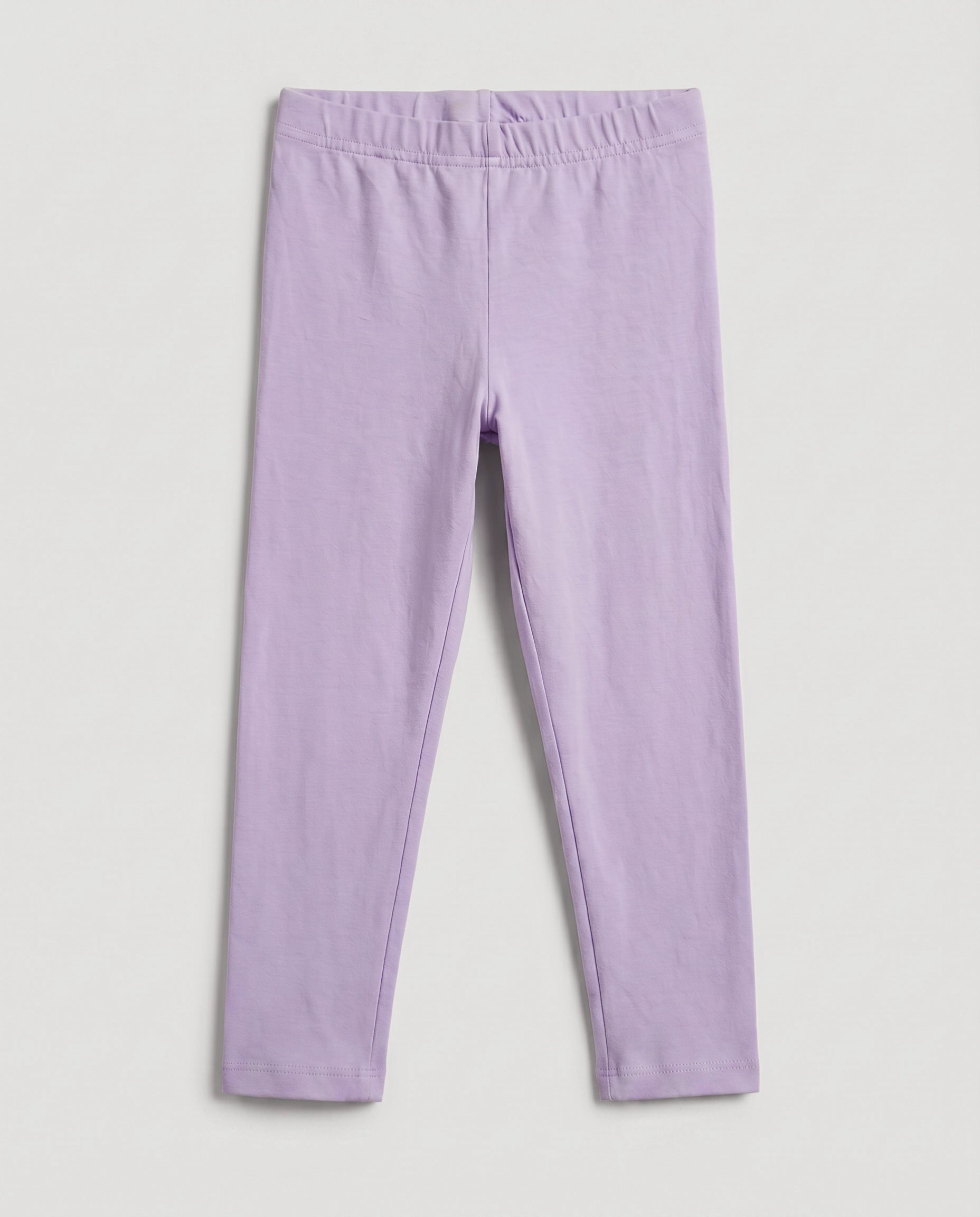 Full-length girls' slim-fit leggings in baby purple, plain design with elasticated waistband, laid flat on a light grey background.