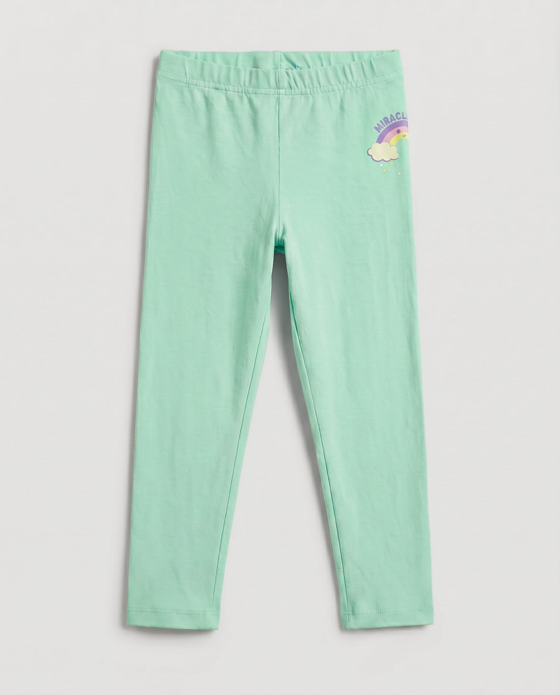 Full-length girls' slim-fit leggings in fresh mint green with a small rainbow and cloud "Miracle" graphic on the upper right hip, elasticated waistband, laid flat on a light grey background.