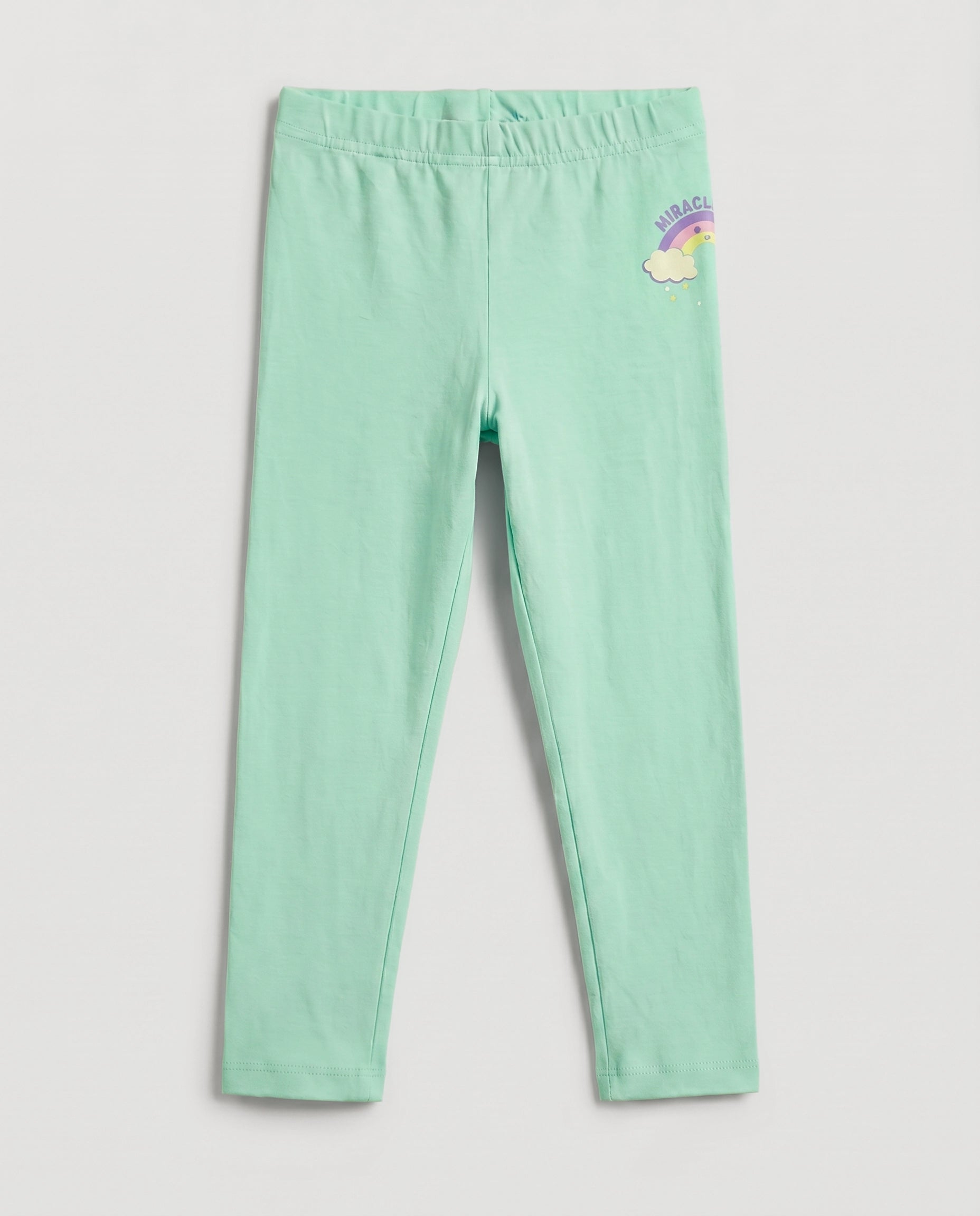 Full-length girls' slim-fit leggings in fresh mint green with a small rainbow and cloud "Miracle" graphic on the upper right hip, elasticated waistband, laid flat on a light grey background.