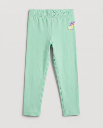 Full-length girls' slim-fit leggings in fresh mint green with a small rainbow and cloud "Miracle" graphic on the upper right hip, elasticated waistband, laid flat on a light grey background.