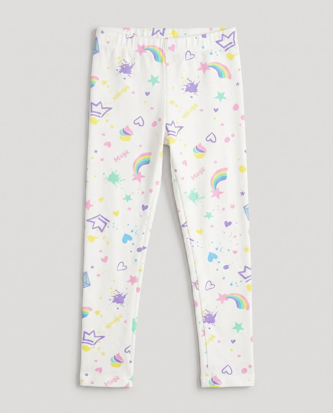 
Full-length white girls' slim-fit leggings with all-over pastel magic-themed print including rainbows, stars, hearts, crowns, cupcakes and paint splashes, laid flat on a white background.