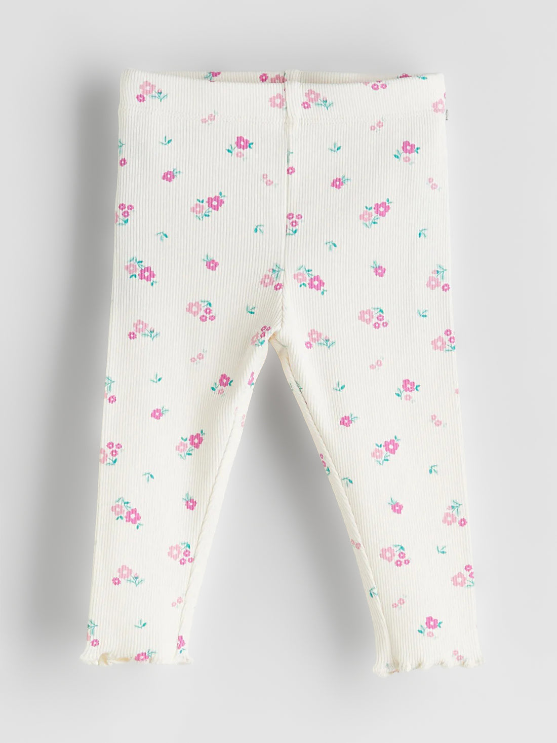 Floral-patterned baby leggings on a light gray background
