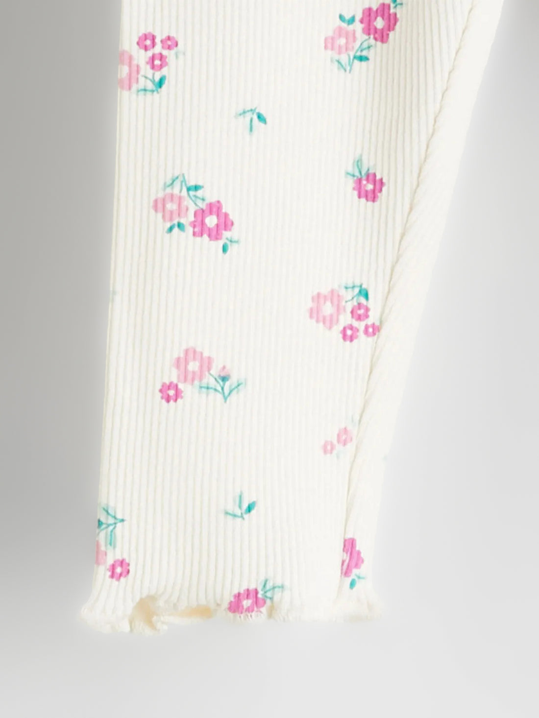 Floral-patterned baby leggings on a light gray background