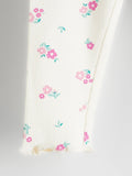 White fabric with pink floral patterns on a gray background