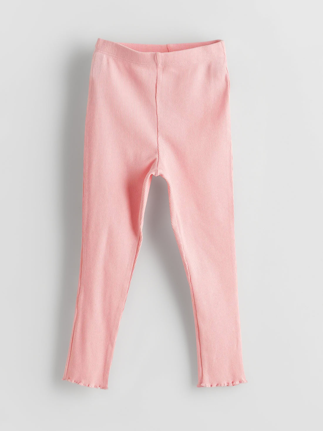 Girl's Soft Pink Ribbed Leggings on a gray background 