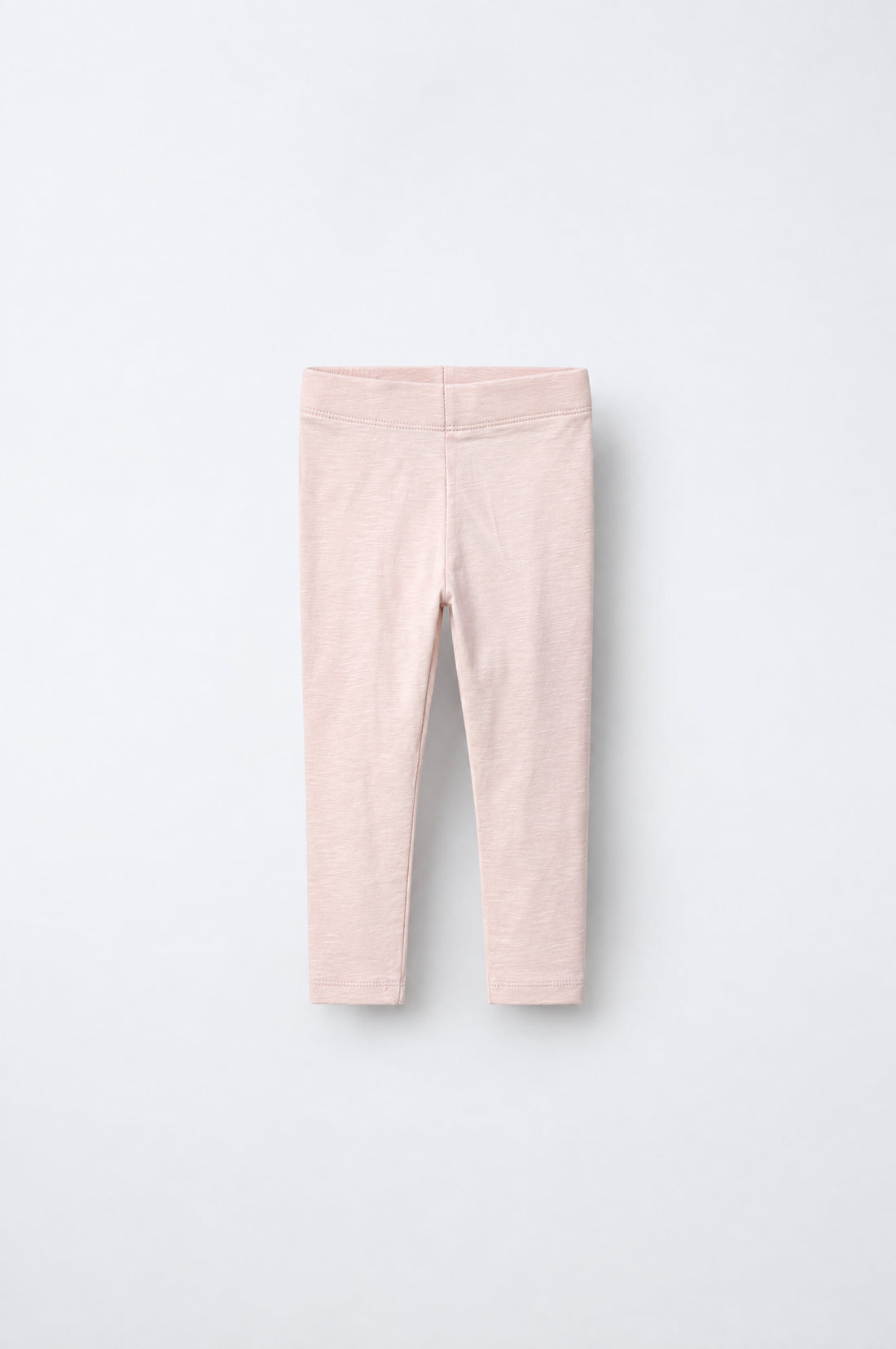 Girls’ blush pink heathered leggings with elastic waistband and slim tapered legs.