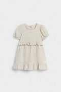 Front view of girls’ beige linen ruffle dress with puff sleeves and tiered hem